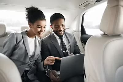 Business professionals in luxury vehicle