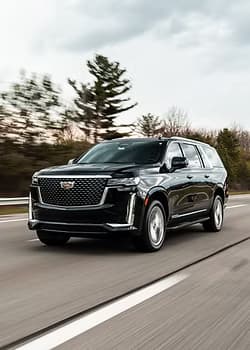 Black Cadillac Escalade SUV on highway