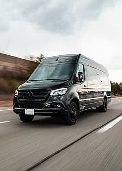 Black Mercedes-Benz Sprinter van on highway